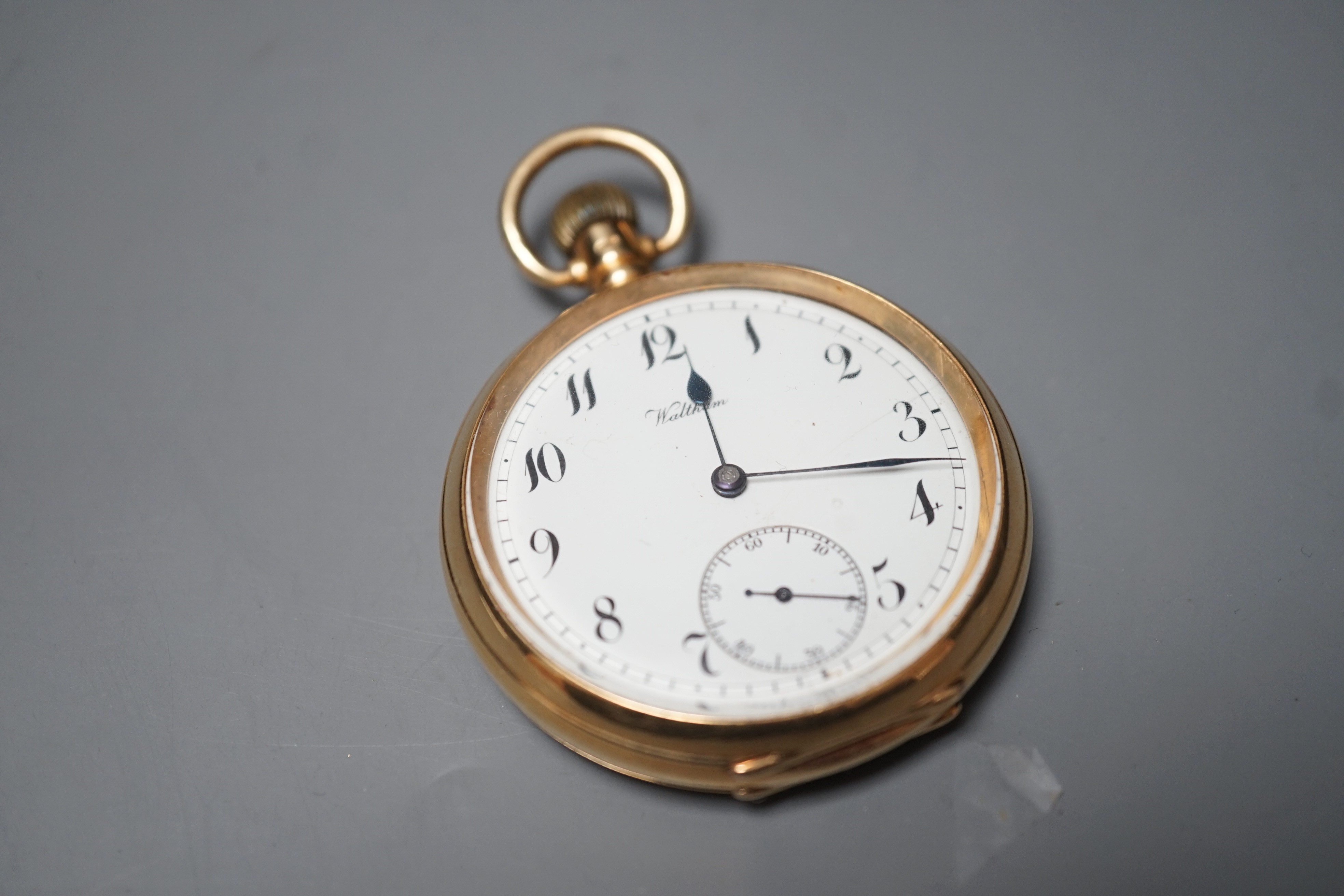A George V 18ct gold Waltham open faced keyless pocket watch, with Arabic dial and subsidiary seconds, case diameter 50mm, gross weight 98.9 grams.
